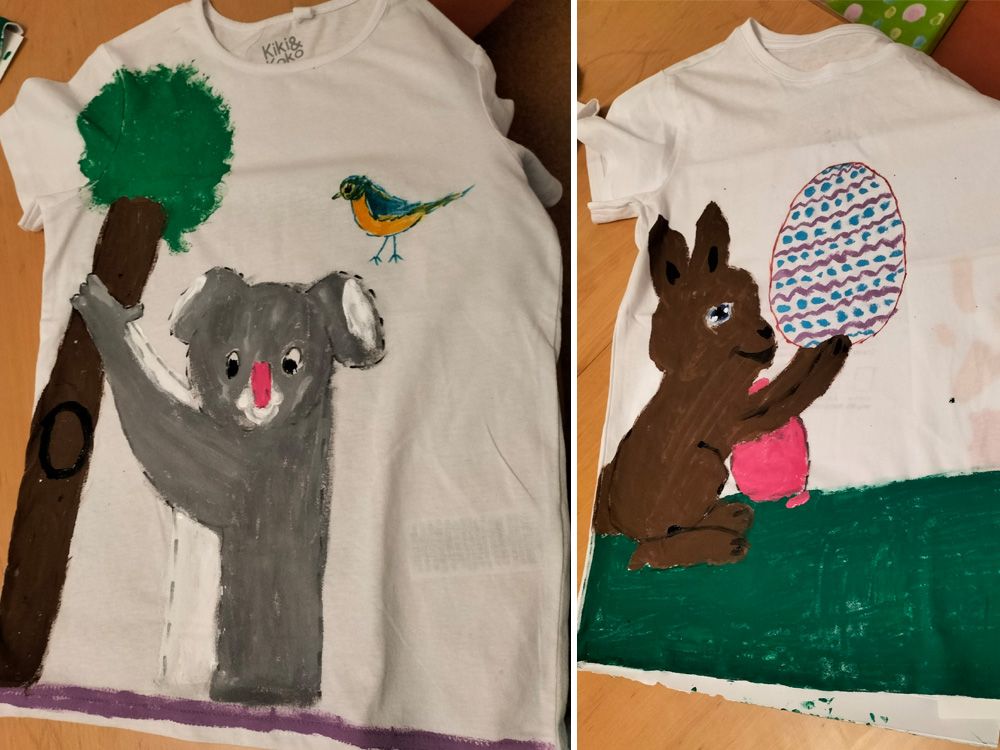 Ein T-Shirt mit einem gemalten Koala, Baum und Vogel sowie einem Hasen mit Osterei